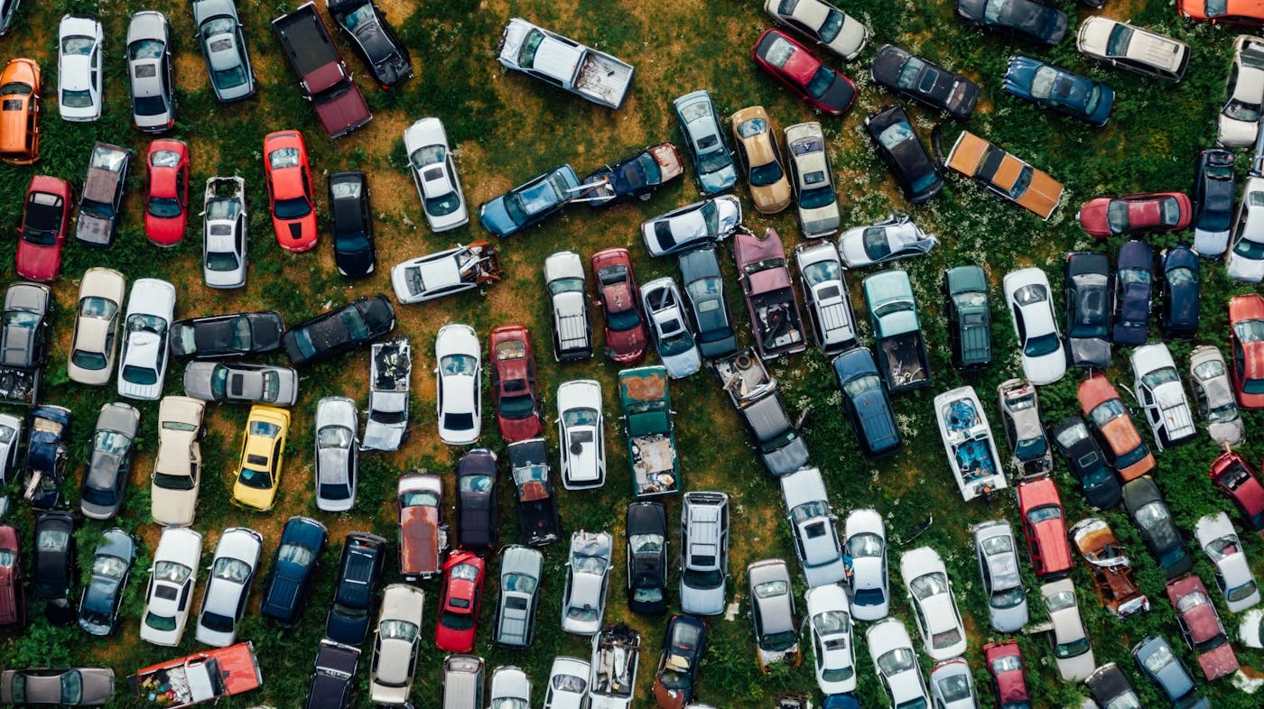 Aerial view of a scrap yard filled with hundreds of used and salvaged cars